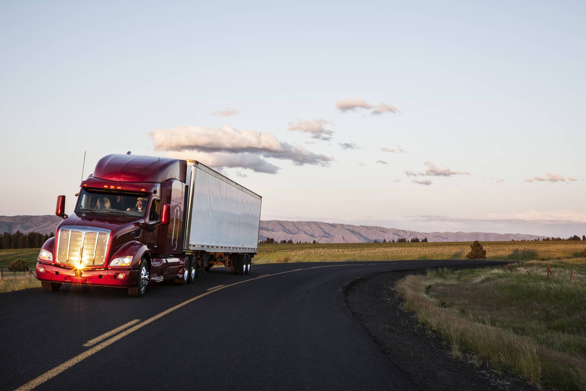 Top Gun Trucking & Rigging truck traveling an Eastern Oregon highway